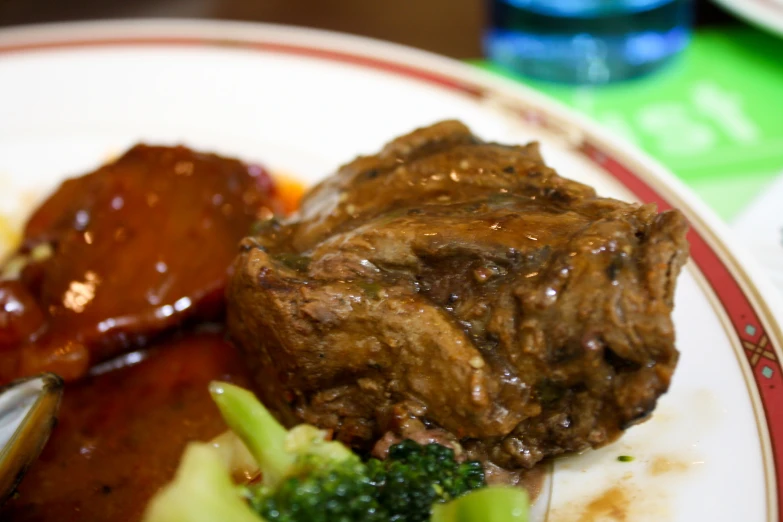 a plate with meat and broccoli is shown