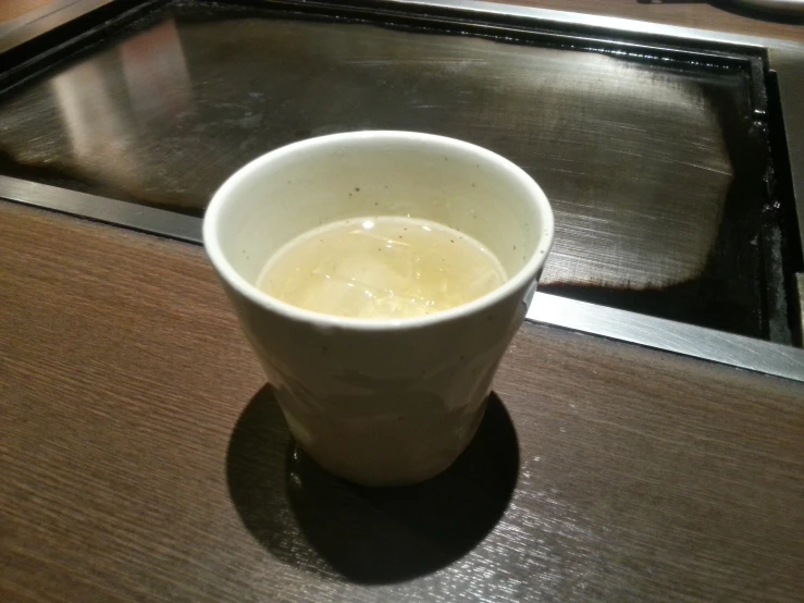 a small cup of water sits on a counter