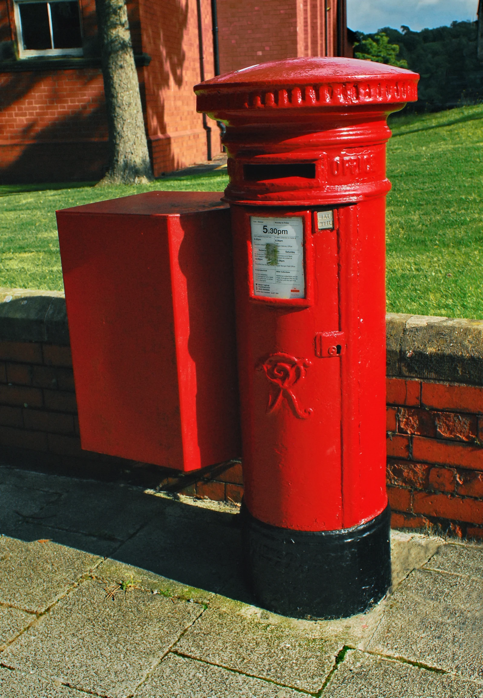 two mail boxes in front of a building