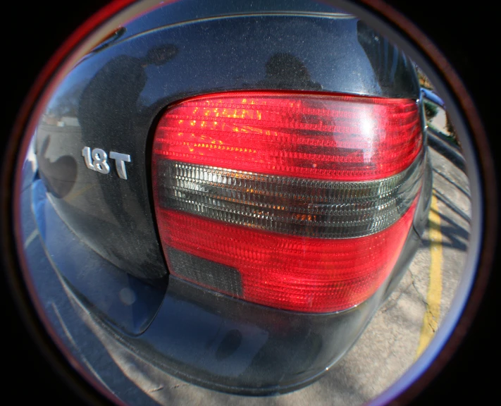 a mirror reflecting the tail light of a car