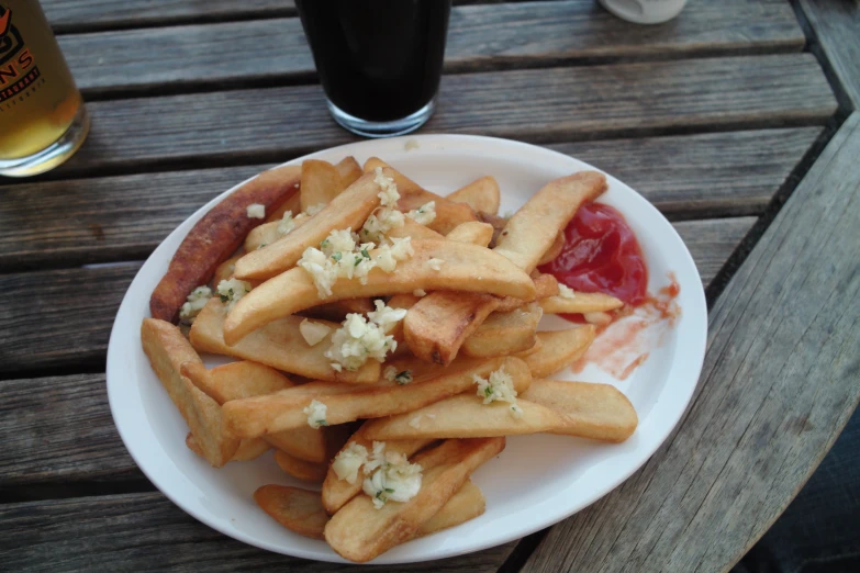 a plate full of fries, ketchup, and some mustard