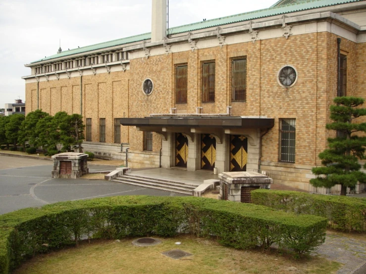 an old building with stone pillars and green top