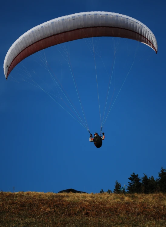 a man in a parasailing suit jumping into the air