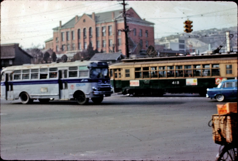 an old pograph of a trolley and busses