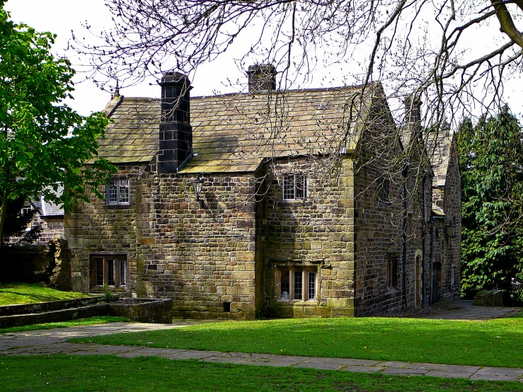 a large brick building in the middle of a forest