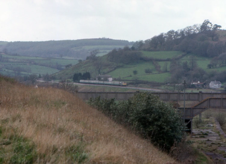 there is a bridge over water and hills