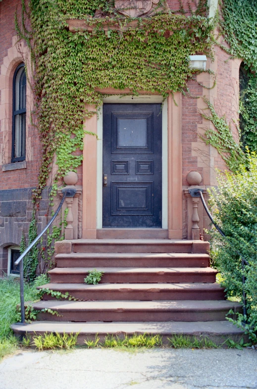 an entrance leading up to a red brick building