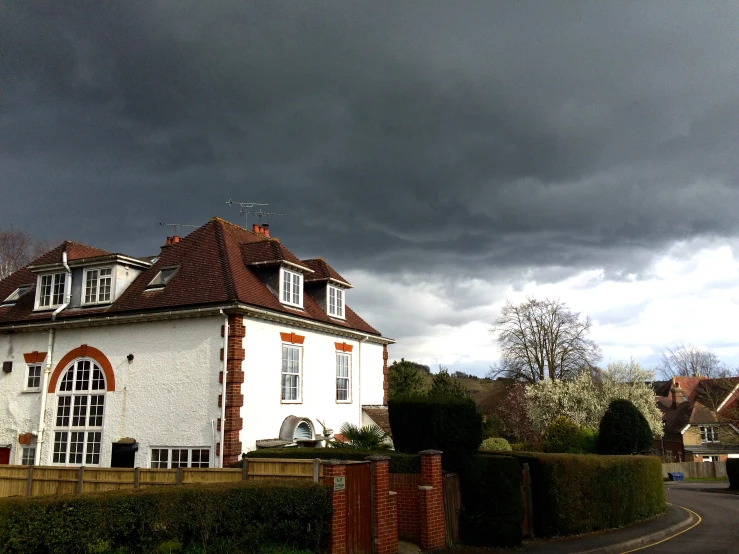 the storm clouds are gathering over the white building