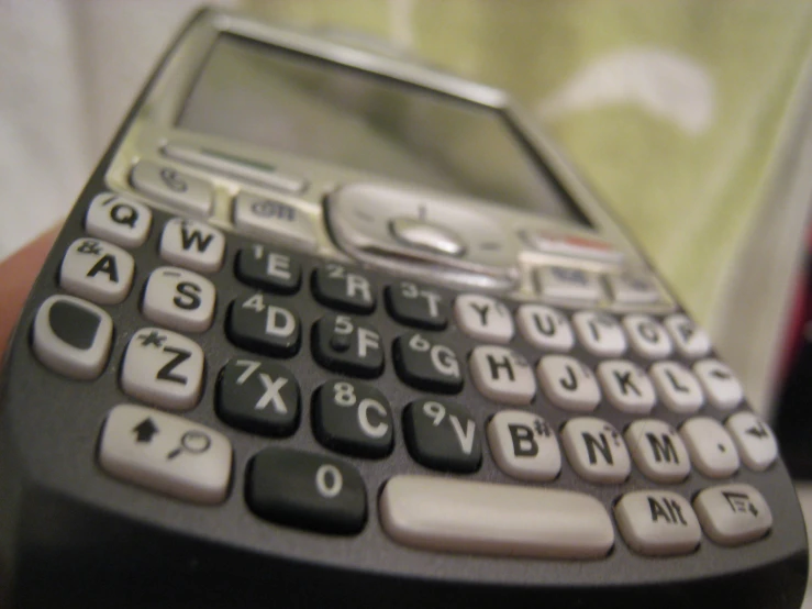 a small phone sitting on top of a person's hand