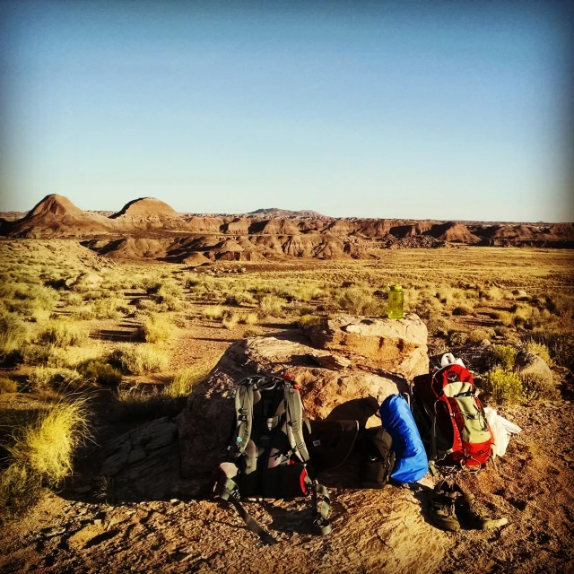 a couple of people camping out in the desert