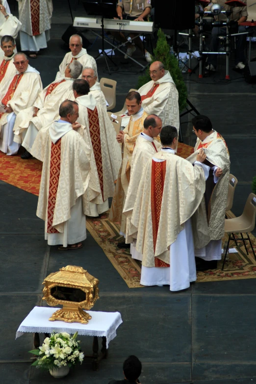 men in white and red uniforms sitting at podiums