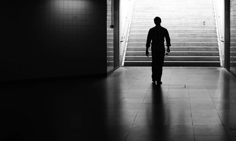 a man that is walking into some stairs