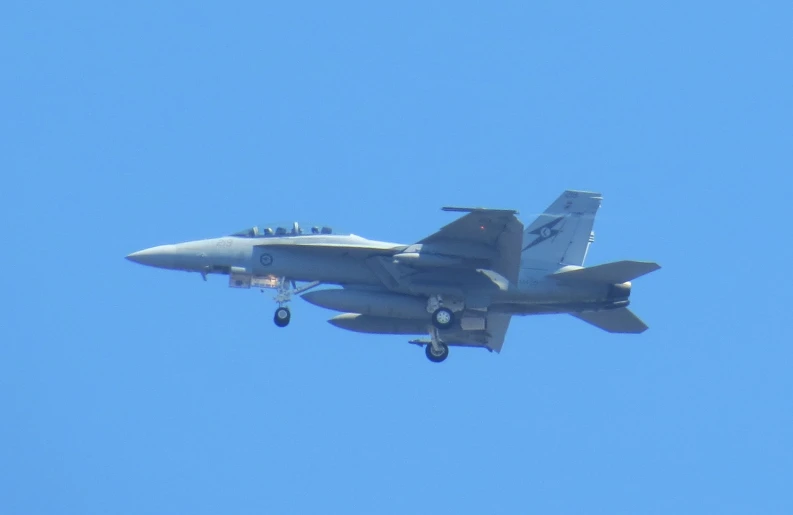 a large aircraft flying in the sky on a clear day