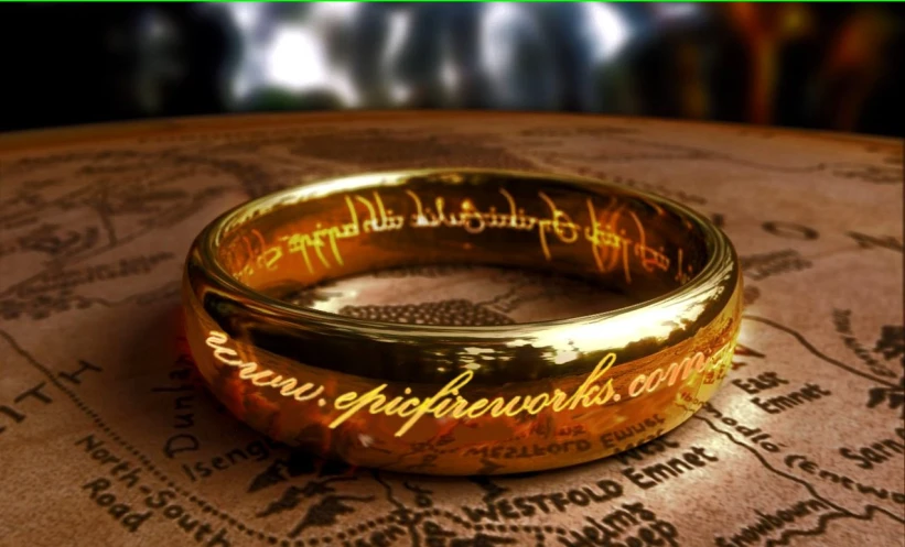 a golden ring with writing on it sitting on top of a table