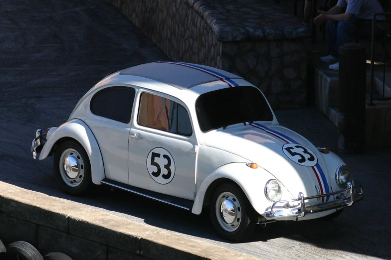 a silver and black car is driving down the street