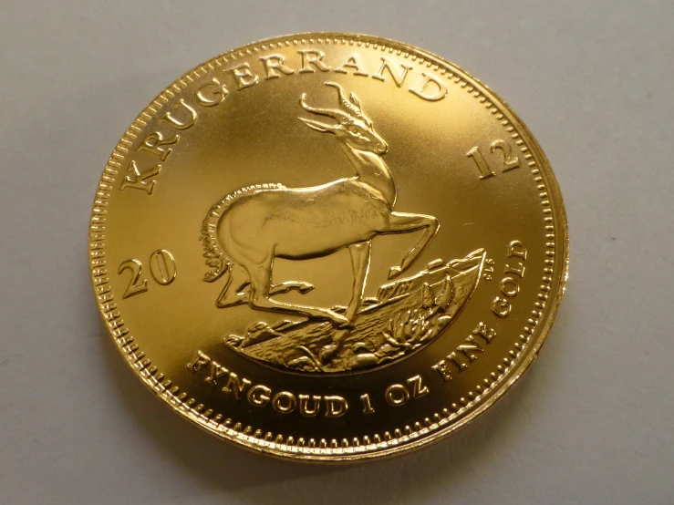 the gold coin features a deer and bird