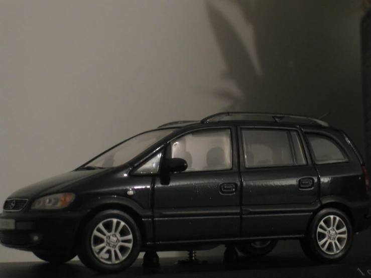 small toy car parked near white wall in building