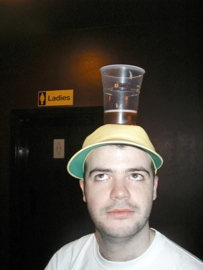 a man in a hat that is stacked on his head