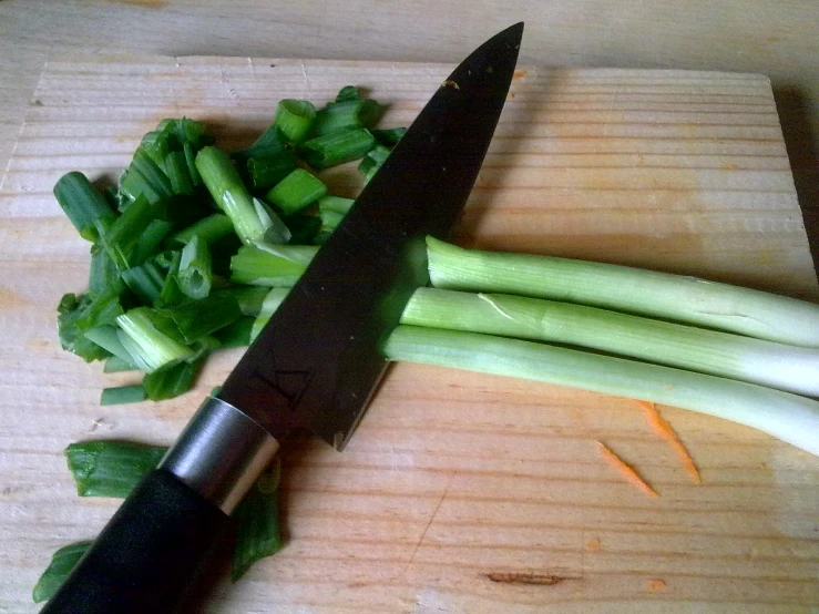 there are celery stalks, cut up with a large knife