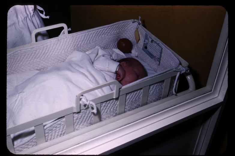 a baby in a crib is taking a nap
