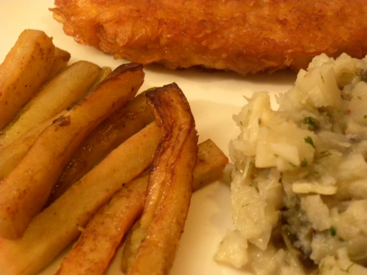 fish and a potato dish with french fries