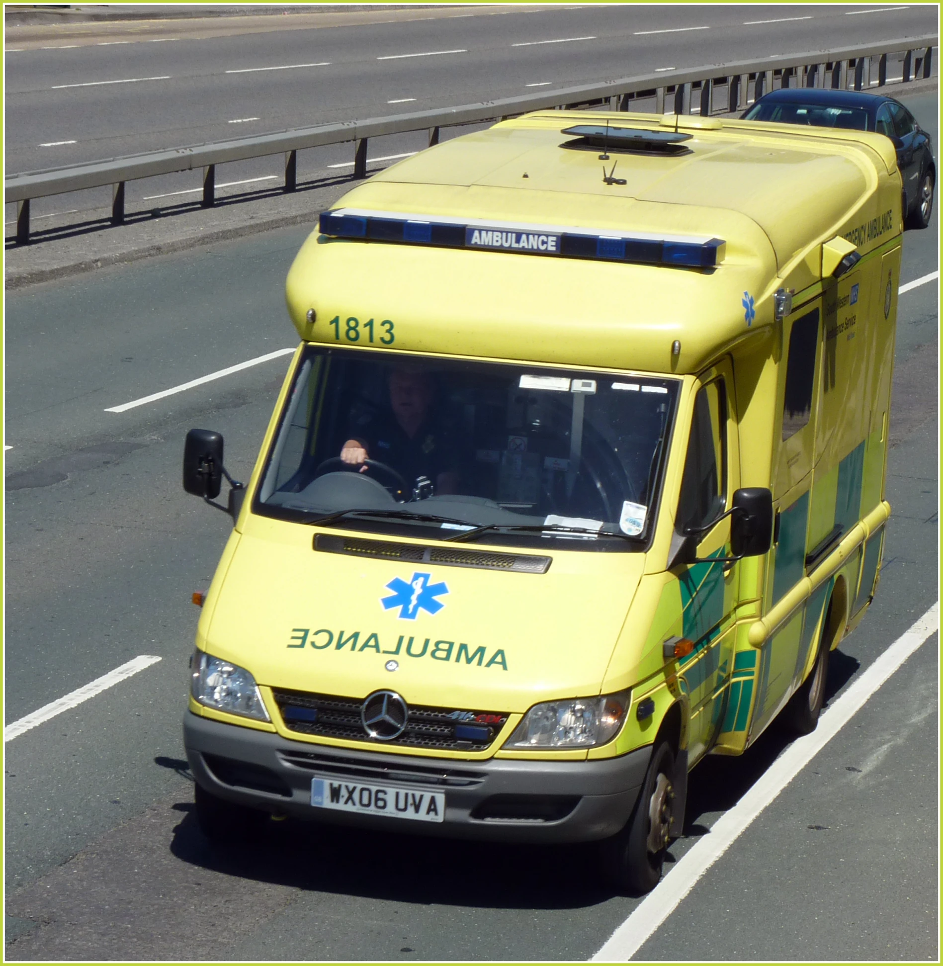 an ambulance is shown on a highway with cars behind it