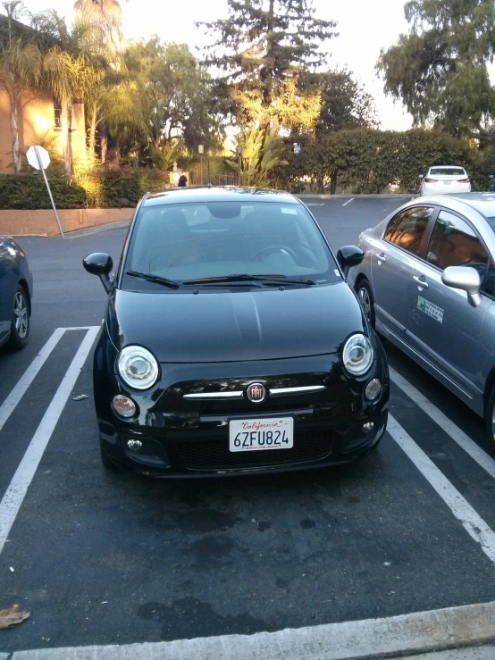 two parked cars in a parking space next to each other