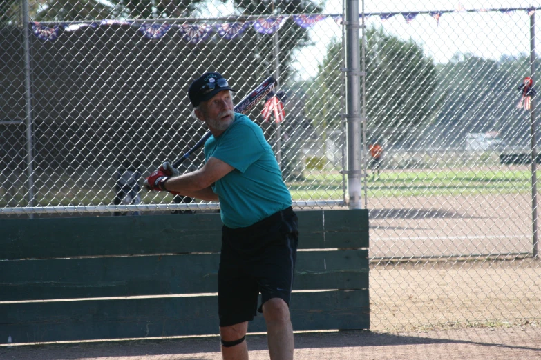 a man taking a swing at a ball with a bat