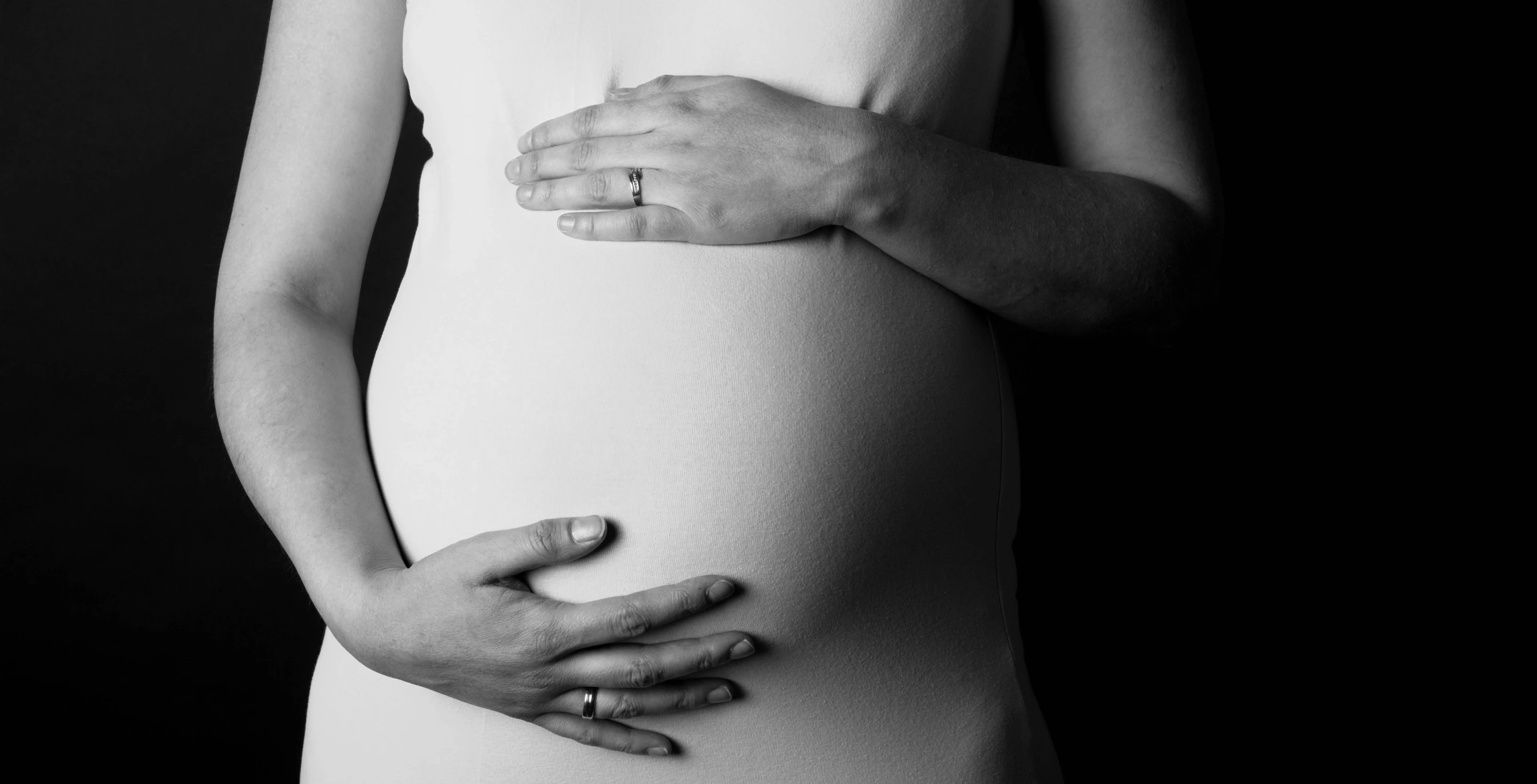 a pregnant woman's belly is covered with a band