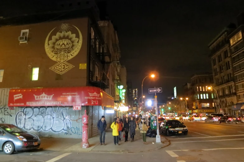 a street scene with people walking on the sidewalk