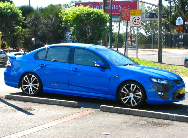 this is a picture of the blue car on the street