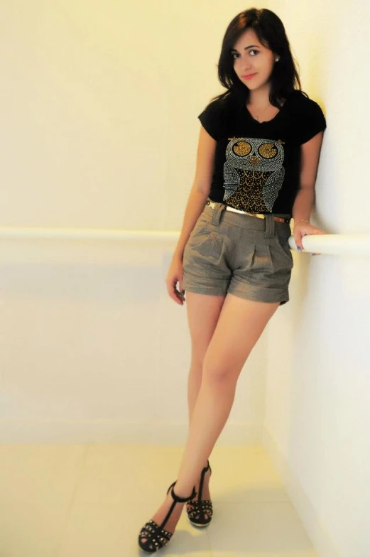 a  poses in a t - shirt and shorts