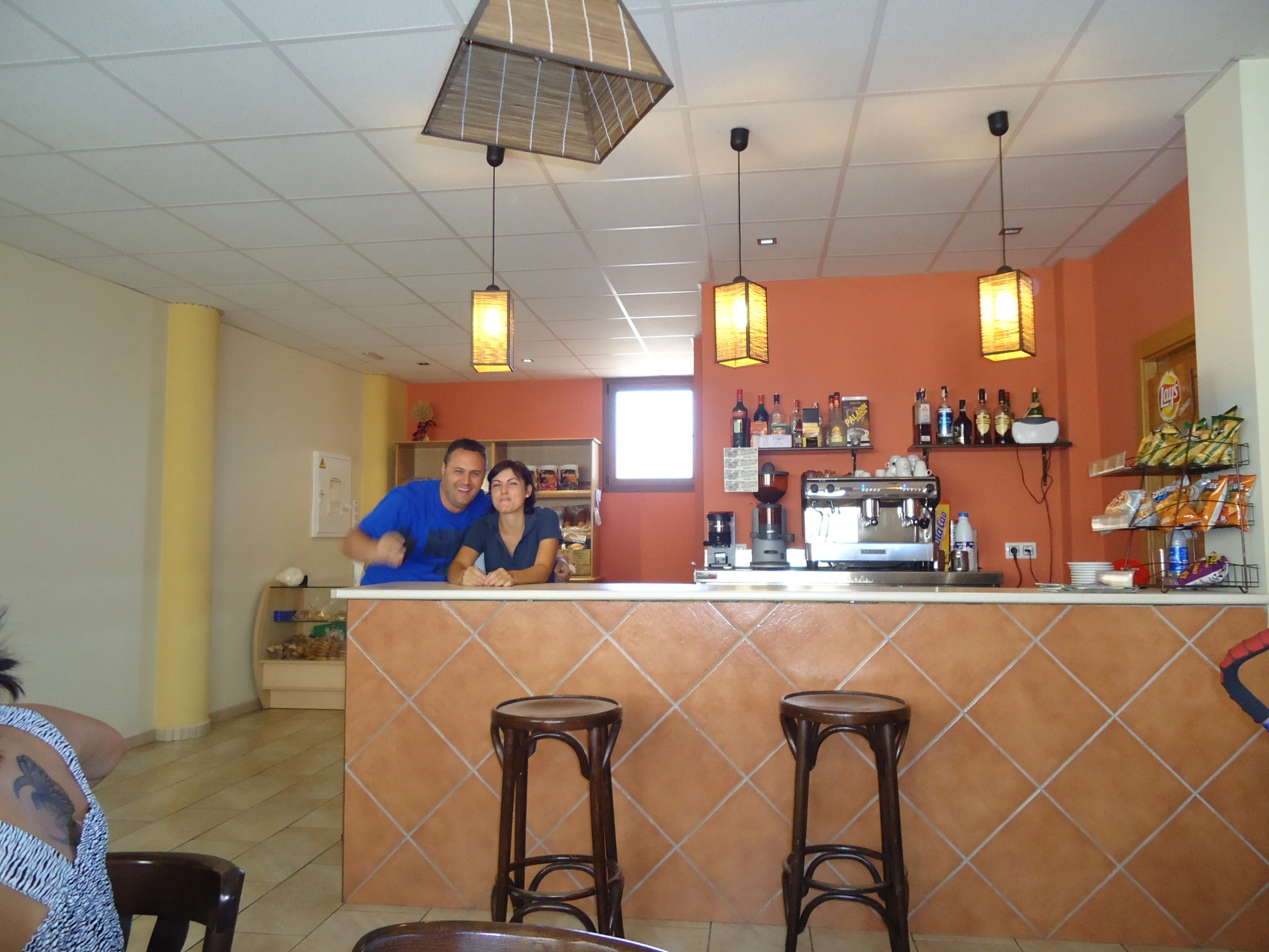 people sitting at a counter with chairs and counters