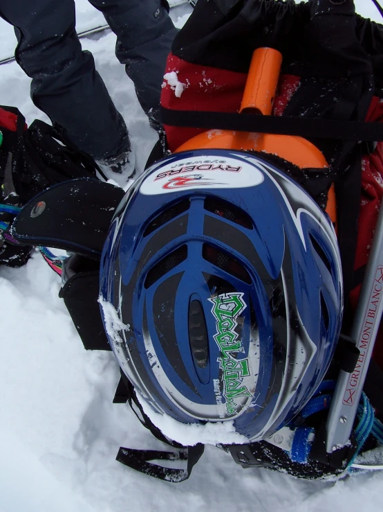 someone in the snow holding up their ski gear