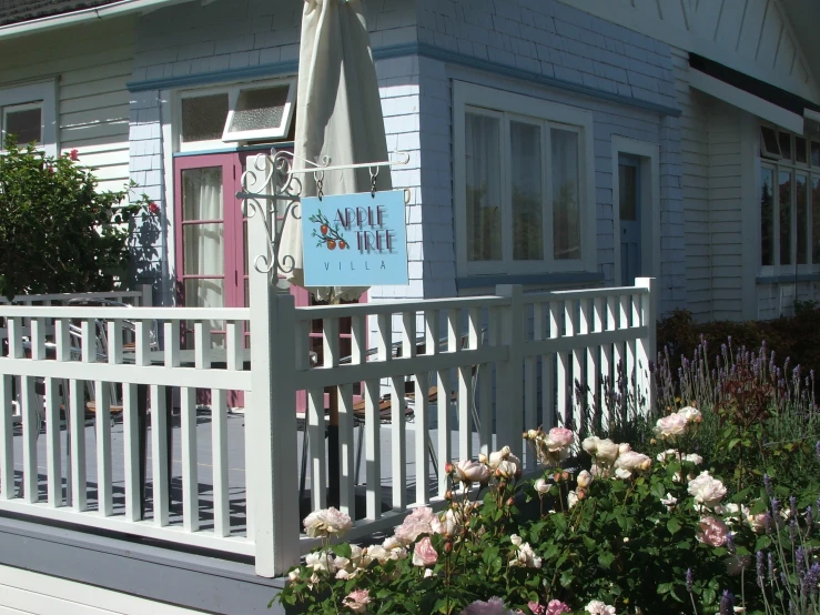 a little house with some pink and blue flowers