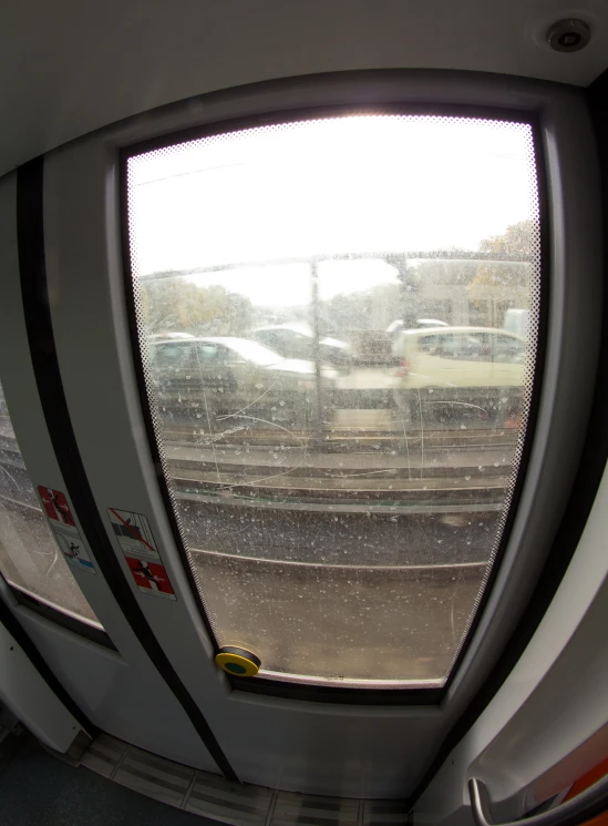 a train platform with cars from inside the windows