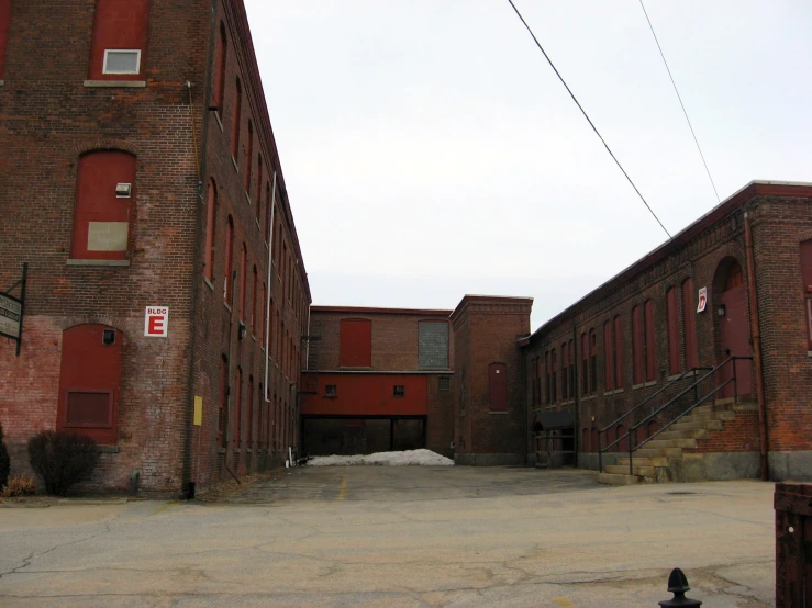 a fire hydrant and large brick buildings in the middle of winter