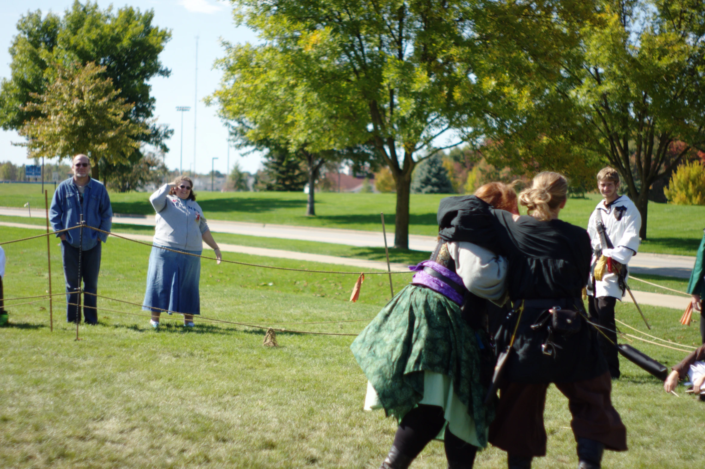 a group of people on a grass field