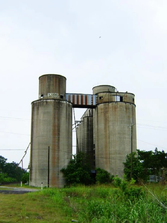 a large cement silos sitting on top of a field