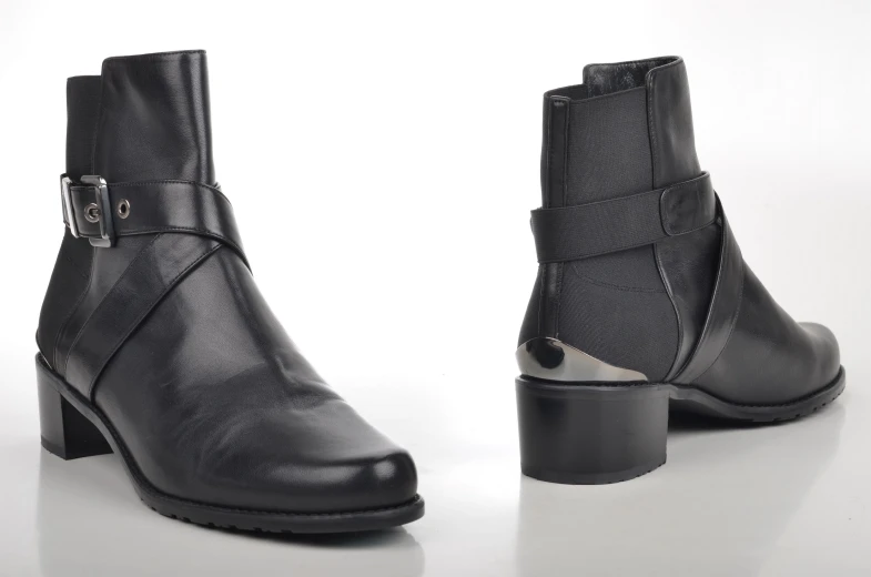 two different black boots with silver details