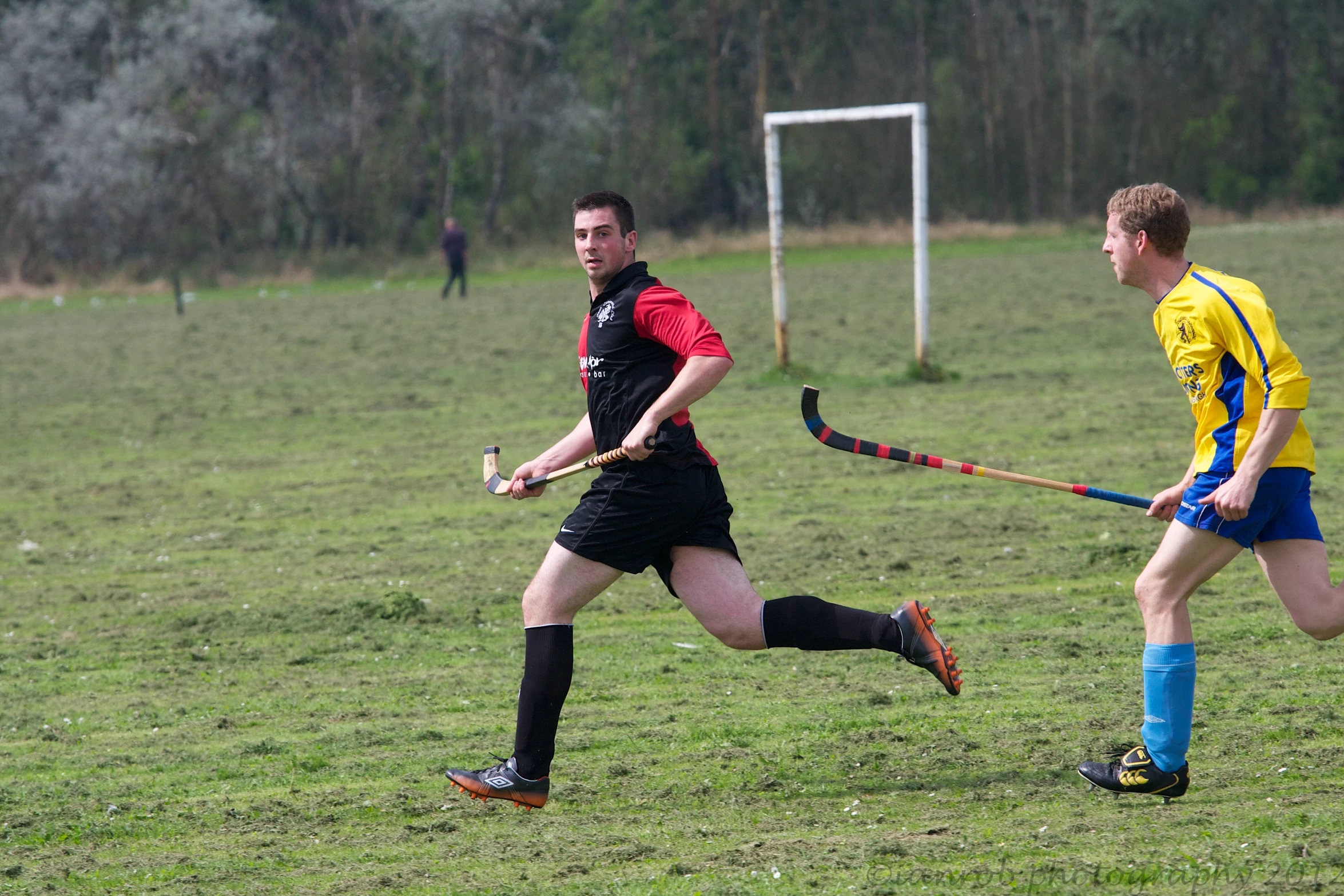 two men play a game of field hockey