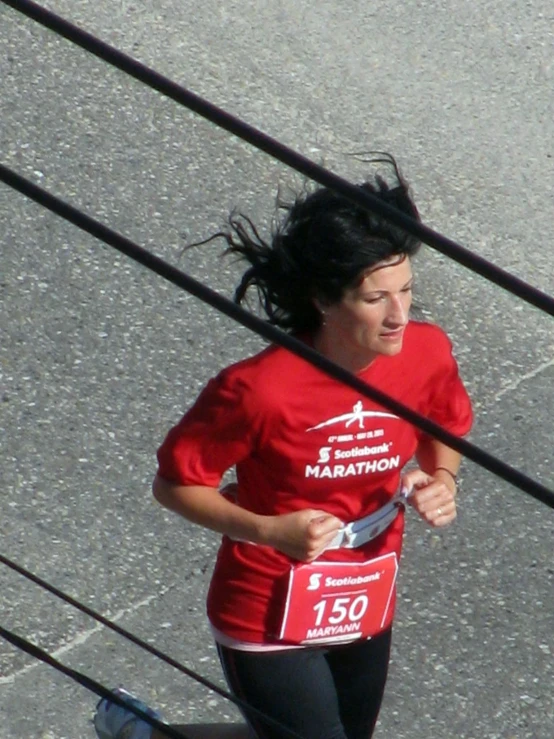 a woman in red shirt running on the street