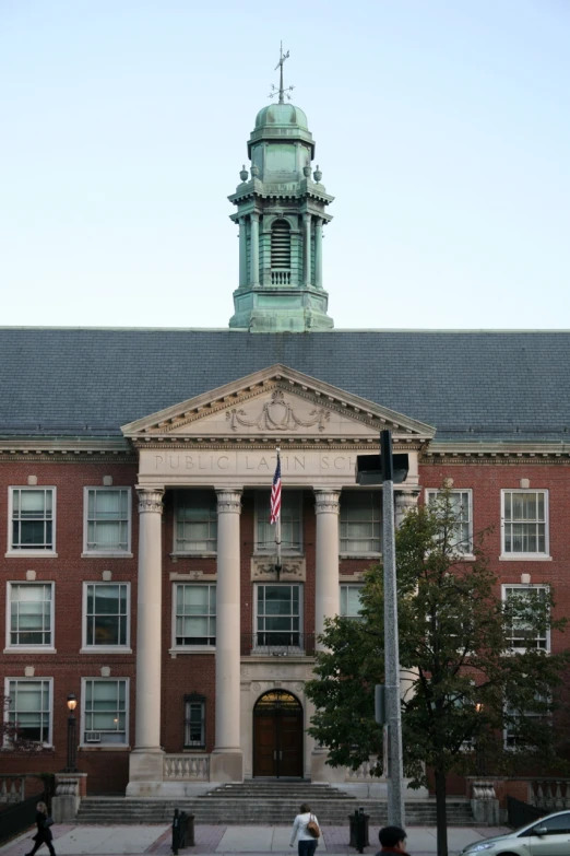 a group of people walking through front of a building