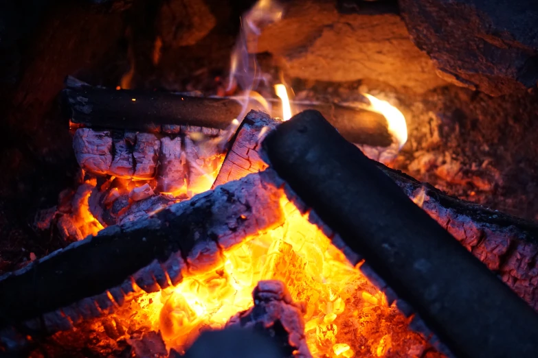 a wood fire is burning brightly on a camp
