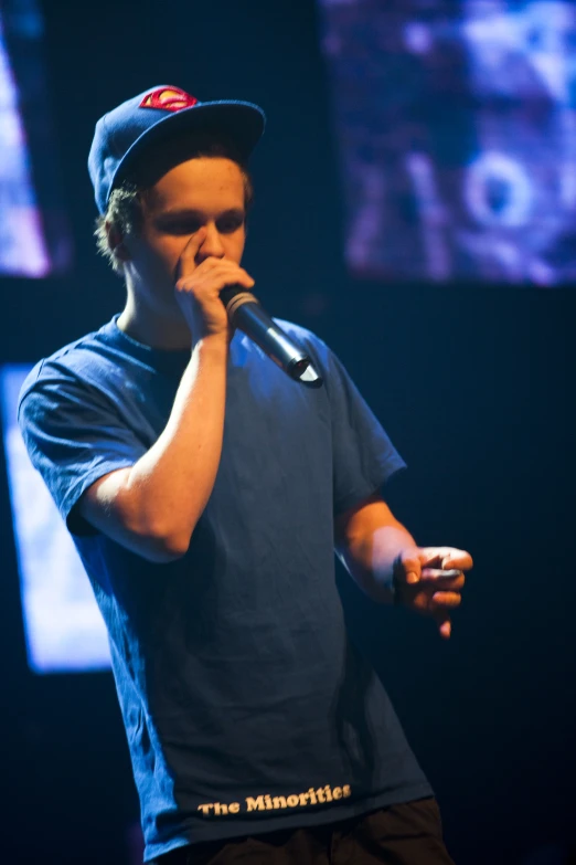 a young man on stage with a microphone