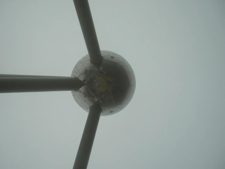 a windmill in the fog under a gray sky