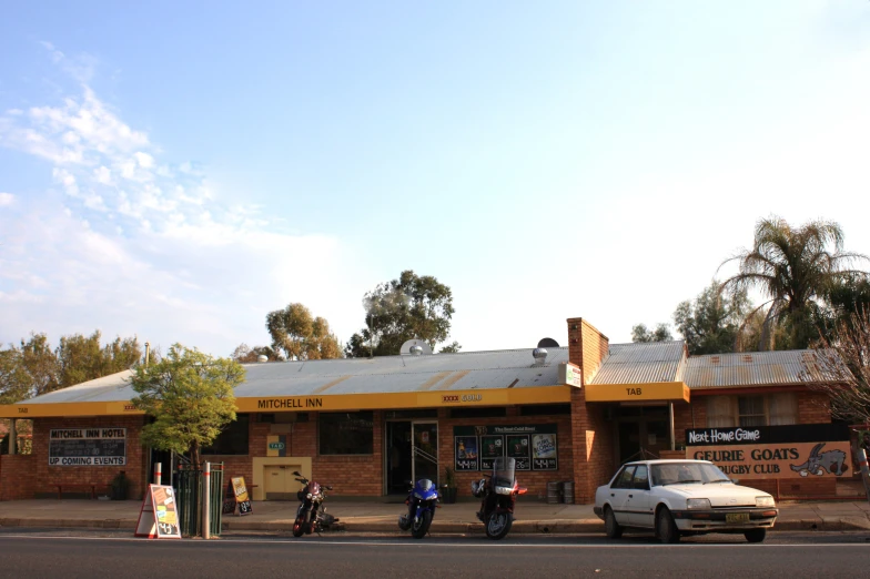 some motorcycles are parked outside a store