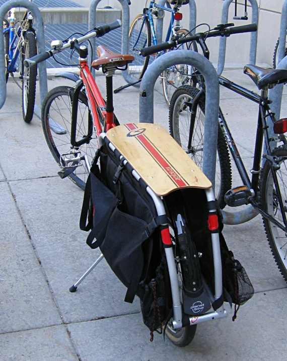 several bicycles on the sidewalk in front of a wall