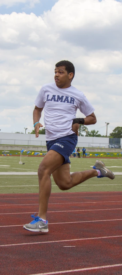 a man running on a track while wearing shorts