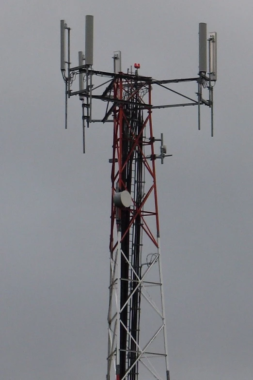 the red and white tower is very tall